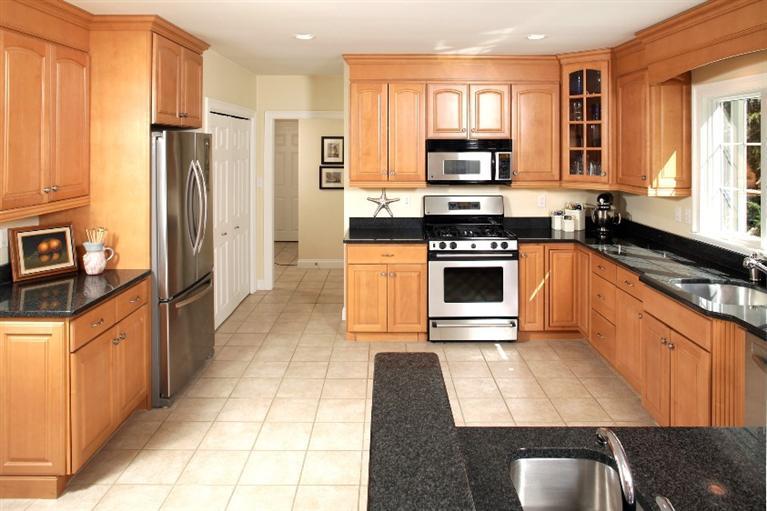 50 Woods Neck Road Orleans, MA 02653 - Photo 4 of 22 a kitchen with stainless steel appliances granite countertop a stove a sink and a refrigerator