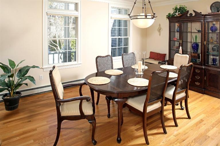 50 Woods Neck Road Orleans, MA 02653 - Photo 5 of 22 a view of a dining room and livingroom with furniture wooden floor and a chandelier
