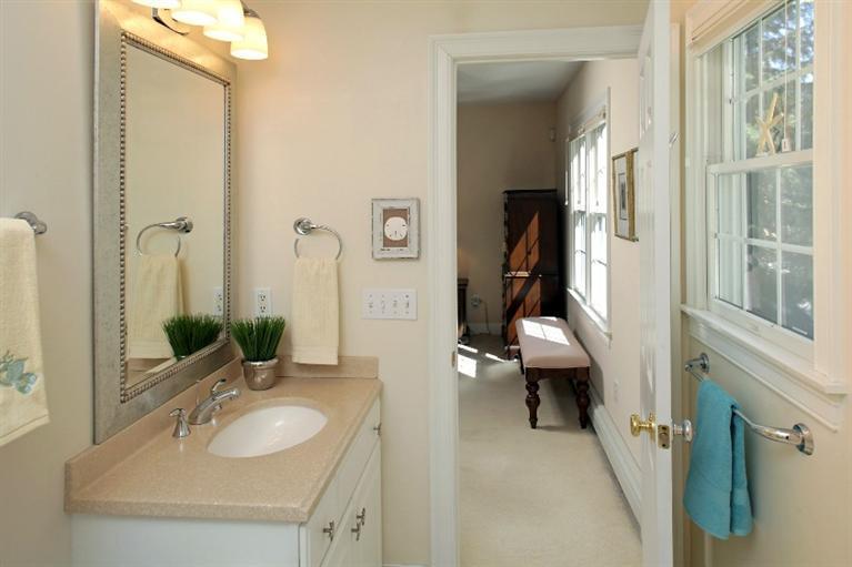 50 Woods Neck Road Orleans, MA 02653 - Photo 8 of 22 a en suite bathroom with a sink and a mirror