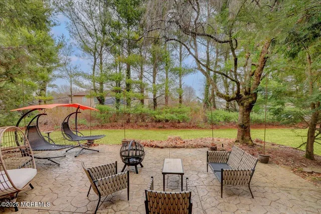 a view of open space with a big yard and large trees