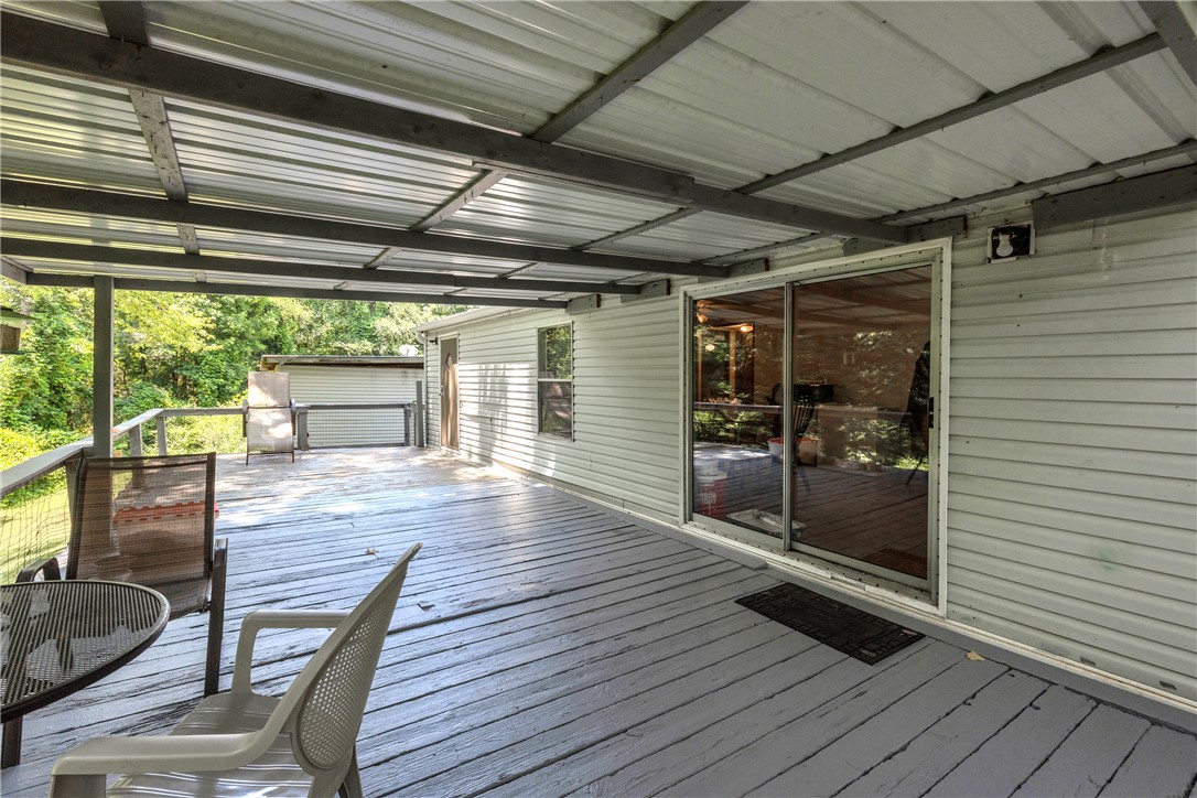 162 Newberry Road Walhalla, SC 29691 - Photo 30 of 50 A spacious covered deck offers serene outdoor living amidst a lush green backdrop.