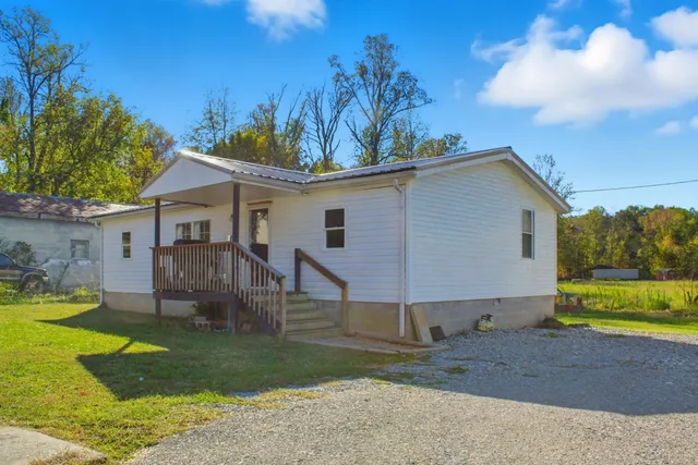 a view of a house with a yard and a garden