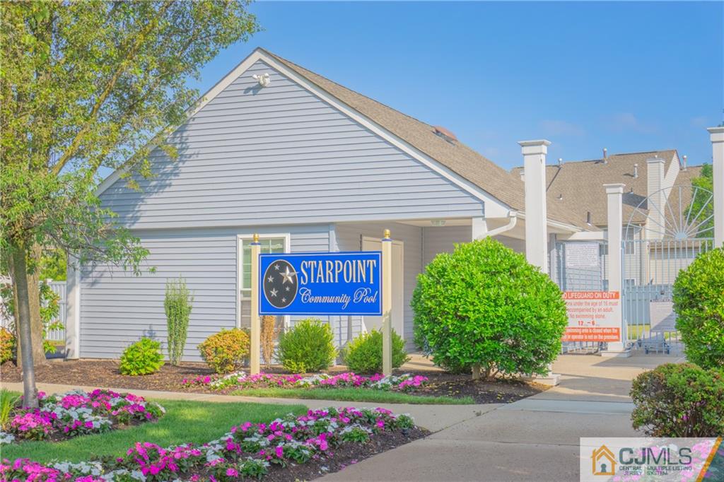 a sign that is in front of flowers