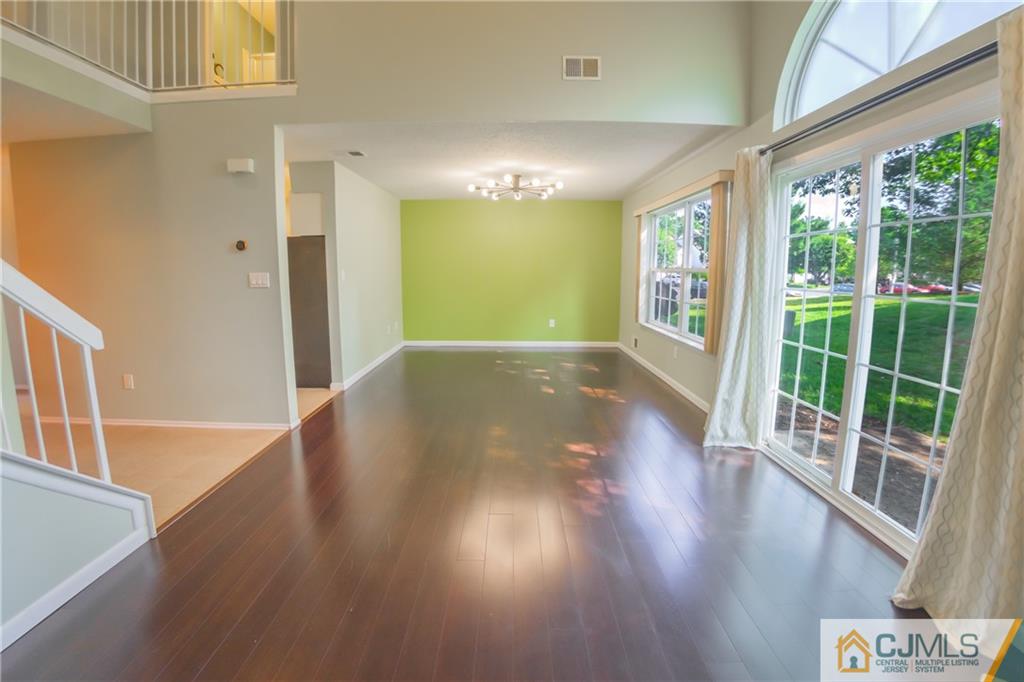 380 Draco Road Piscataway, NJ 08854 - Photo 17 of 35 a view of an empty room with wooden floor and a window