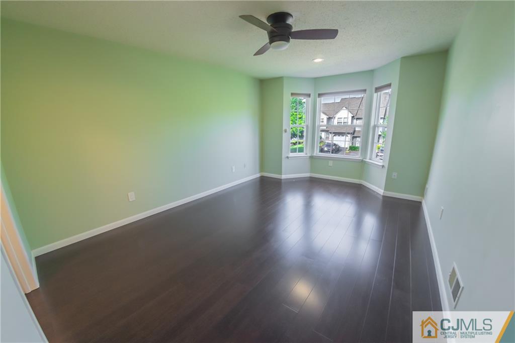 380 Draco Road Piscataway, NJ 08854 - Photo 25 of 35 an empty room with wooden floor and windows
