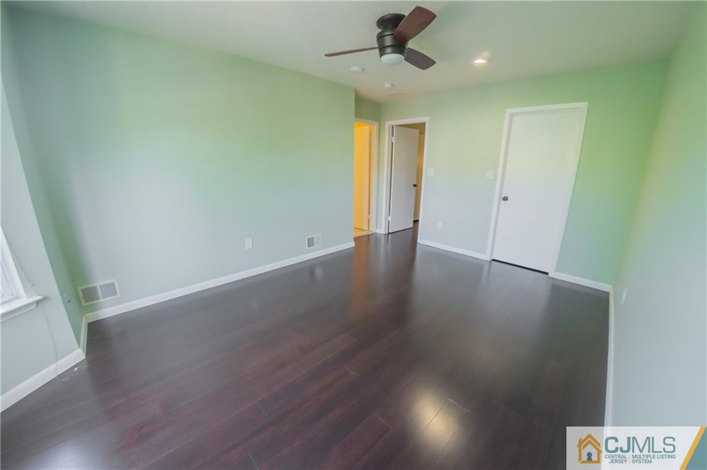 380 Draco Road Piscataway, NJ 08854 - Photo 27 of 35 an empty room with wooden floor fan and windows