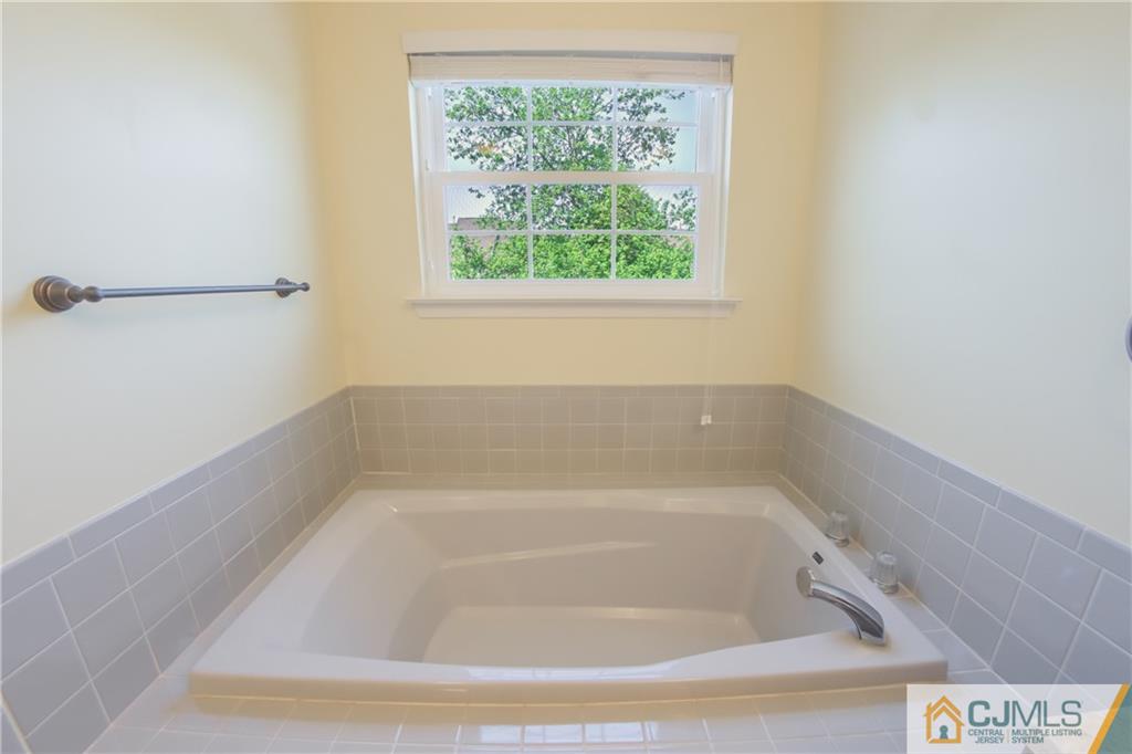 380 Draco Road Piscataway, NJ 08854 - Photo 31 of 35 a white bath tub sitting in a bathroom next to a window