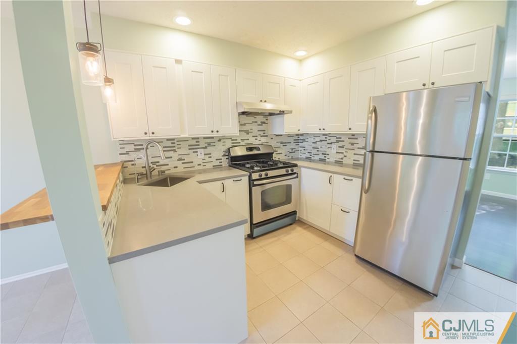 380 Draco Road Piscataway, NJ 08854 - Photo 5 of 35 a kitchen with a stainless steel appliances a refrigerator and a stove