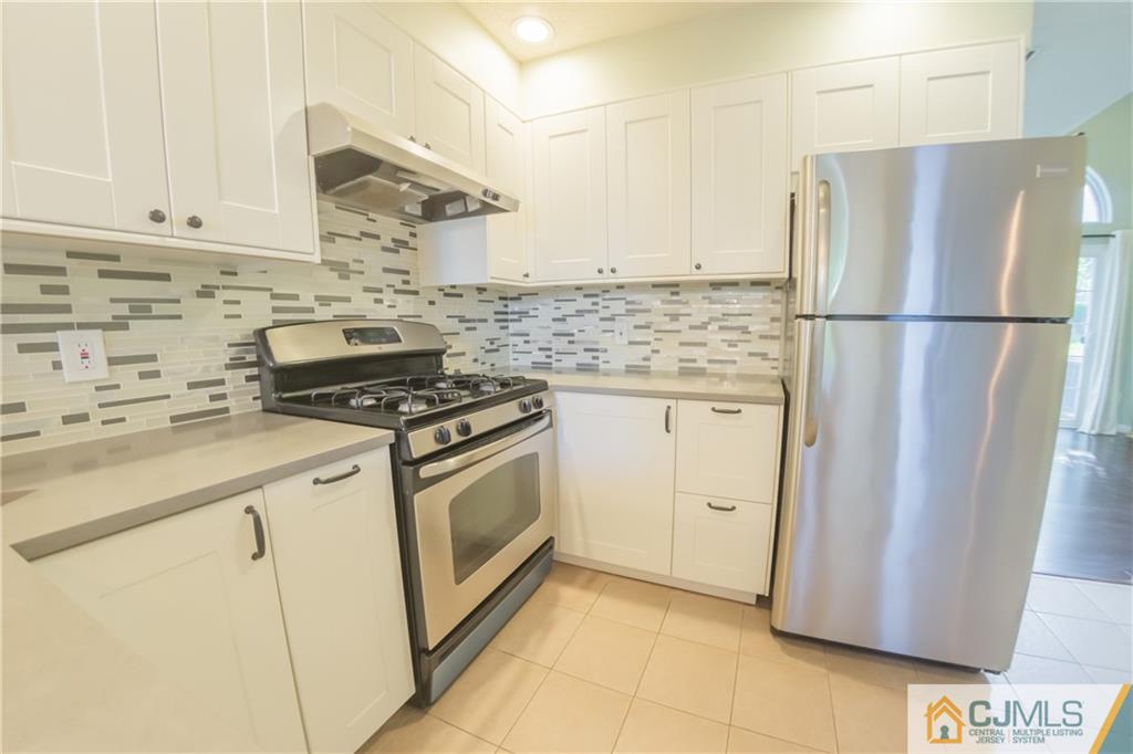 380 Draco Road Piscataway, NJ 08854 - Photo 8 of 35 a kitchen with white cabinets and white appliances