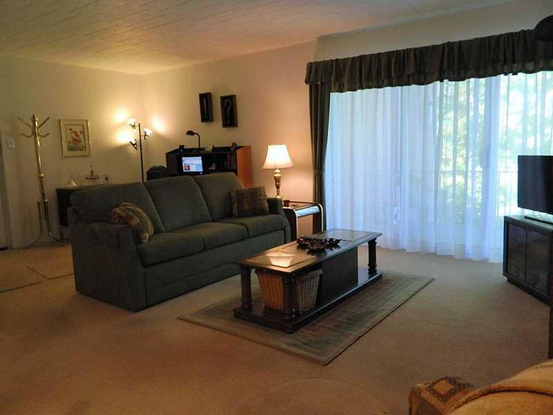 220 Coraopolis Road, Unit E8 Coraopolis, PA 15108 - Photo 2 of 17 Living Room. Entertain or just relax in this large Living Room filled with natural light . Plush neutral carpeting, newer sheers, newer sliding glass doors leading to large concrete private deck.