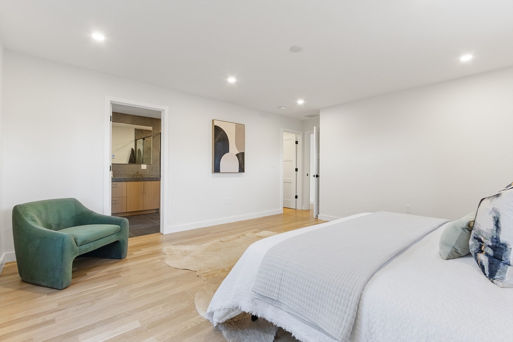 111 Albemarle Road Waltham, MA 02452 - Photo 13 of 32 a spacious bedroom with a bed and a couch