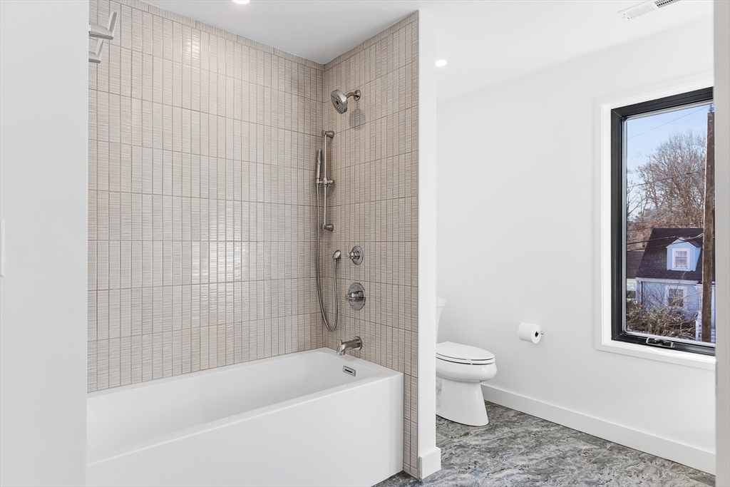 111 Albemarle Road Waltham, MA 02452 - Photo 24 of 32 a bathroom with a bathtub shower and toilet