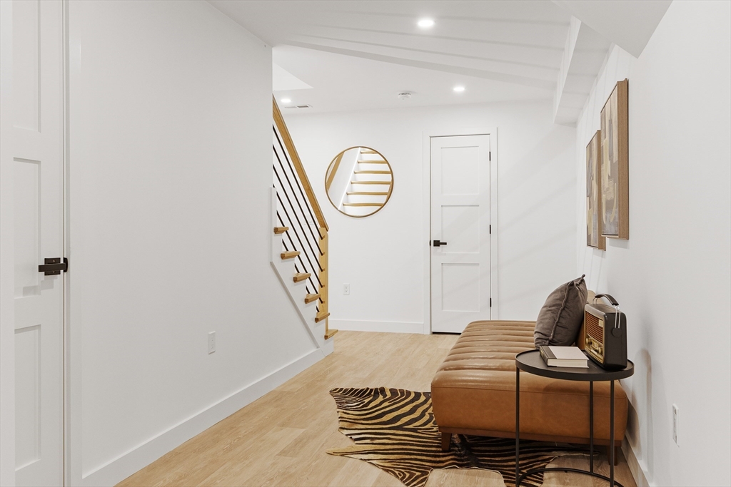 111 Albemarle Road Waltham, MA 02452 - Photo 25 of 32 a living room with furniture and a wooden floor