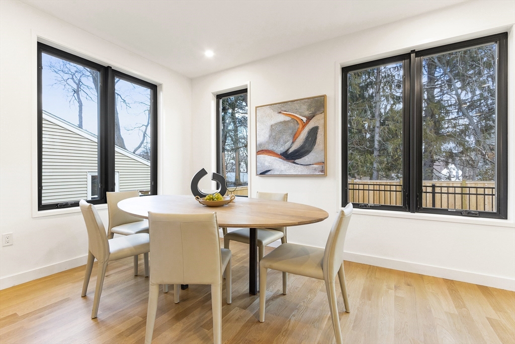 111 Albemarle Road Waltham, MA 02452 - Photo 9 of 32 a view of a dining room with furniture large windows and wooden floor