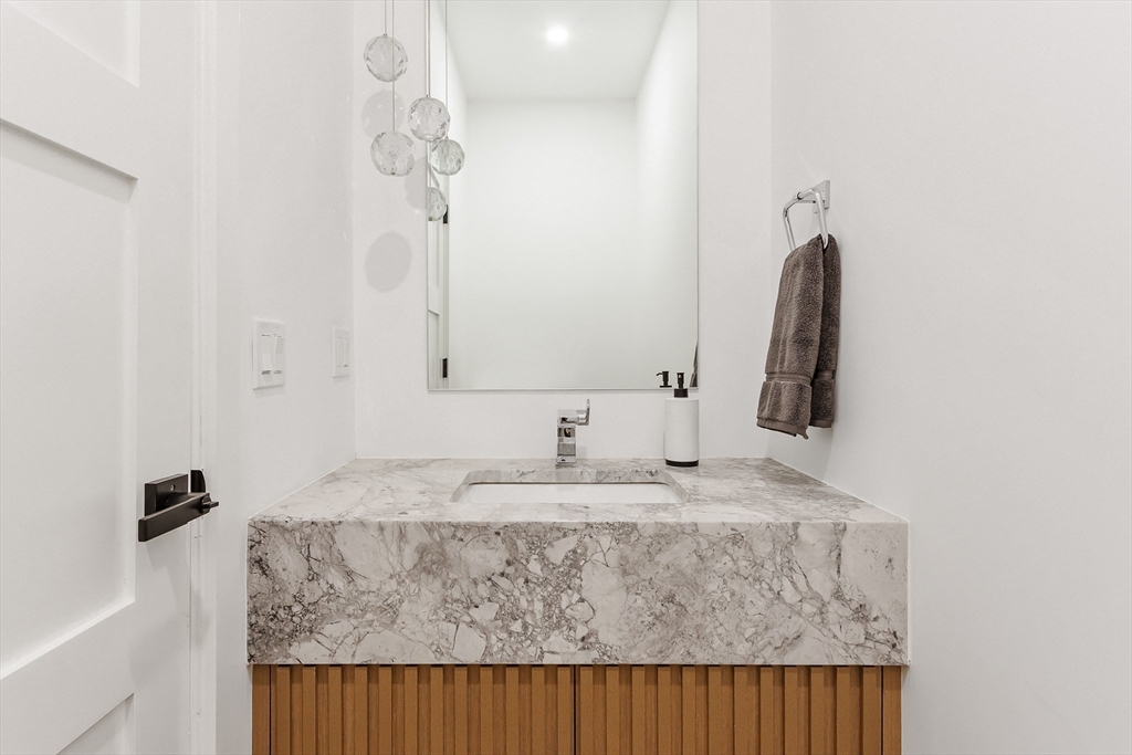 111 Albemarle Road Waltham, MA 02452 - Photo 10 of 32 a bathroom with a granite countertop sink and a mirror