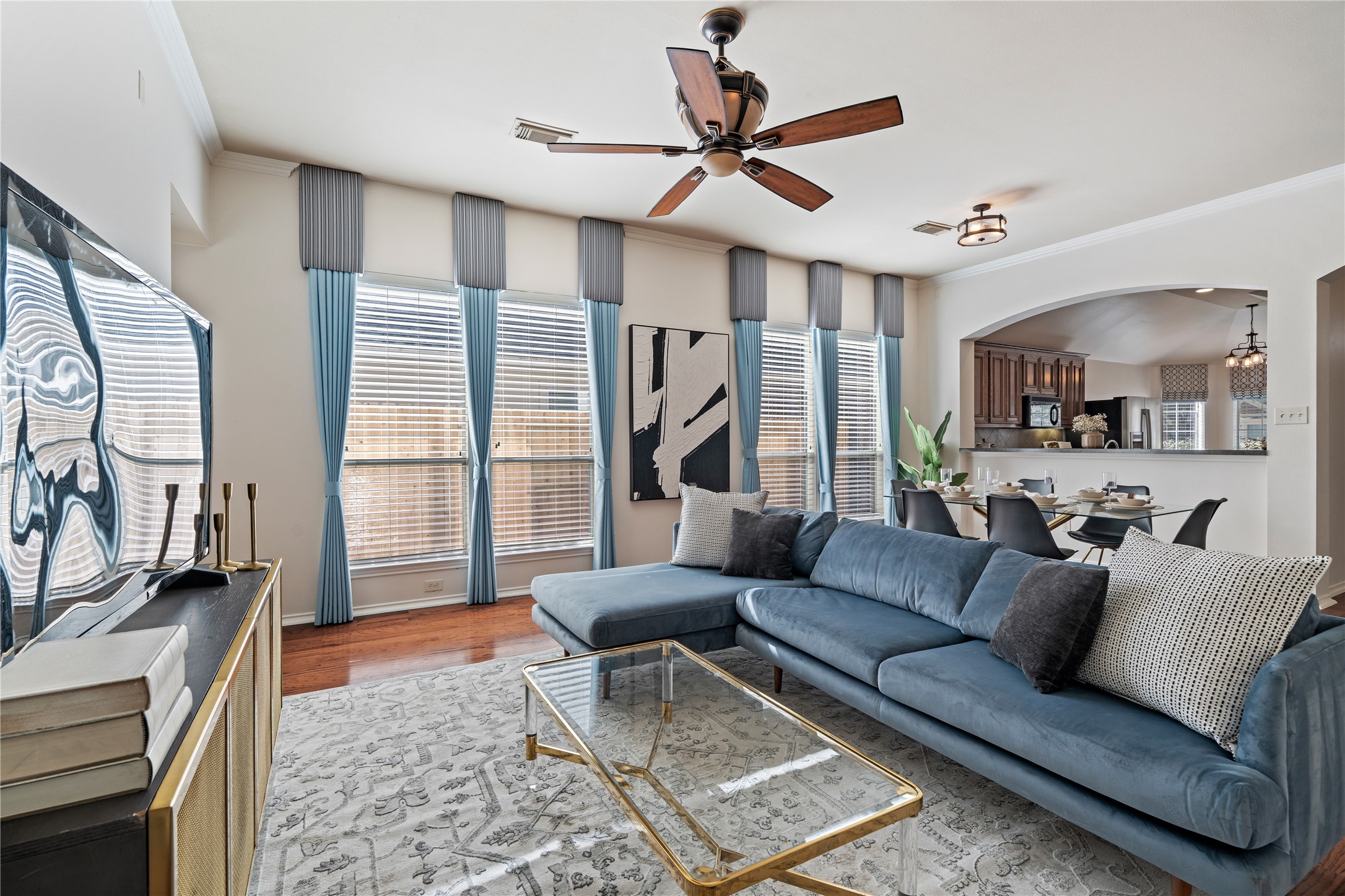 4323 Sunlit Pass Loop Humble, TX 77396 - Photo 10 of 30 a living room with furniture a large window and a flat screen tv