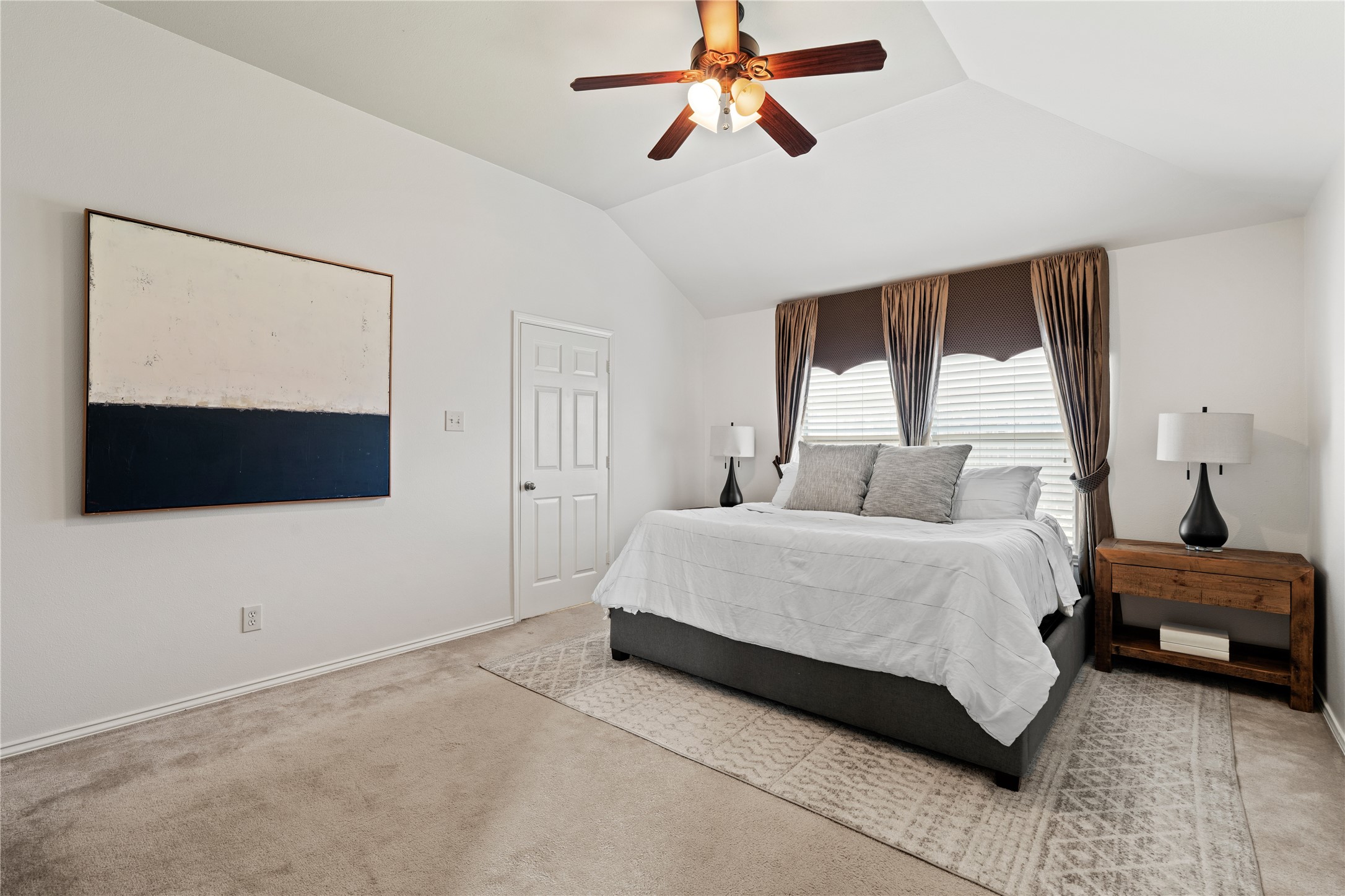 4323 Sunlit Pass Loop Humble, TX 77396 - Photo 15 of 30 a bedroom with a bed a flat screen tv and a window