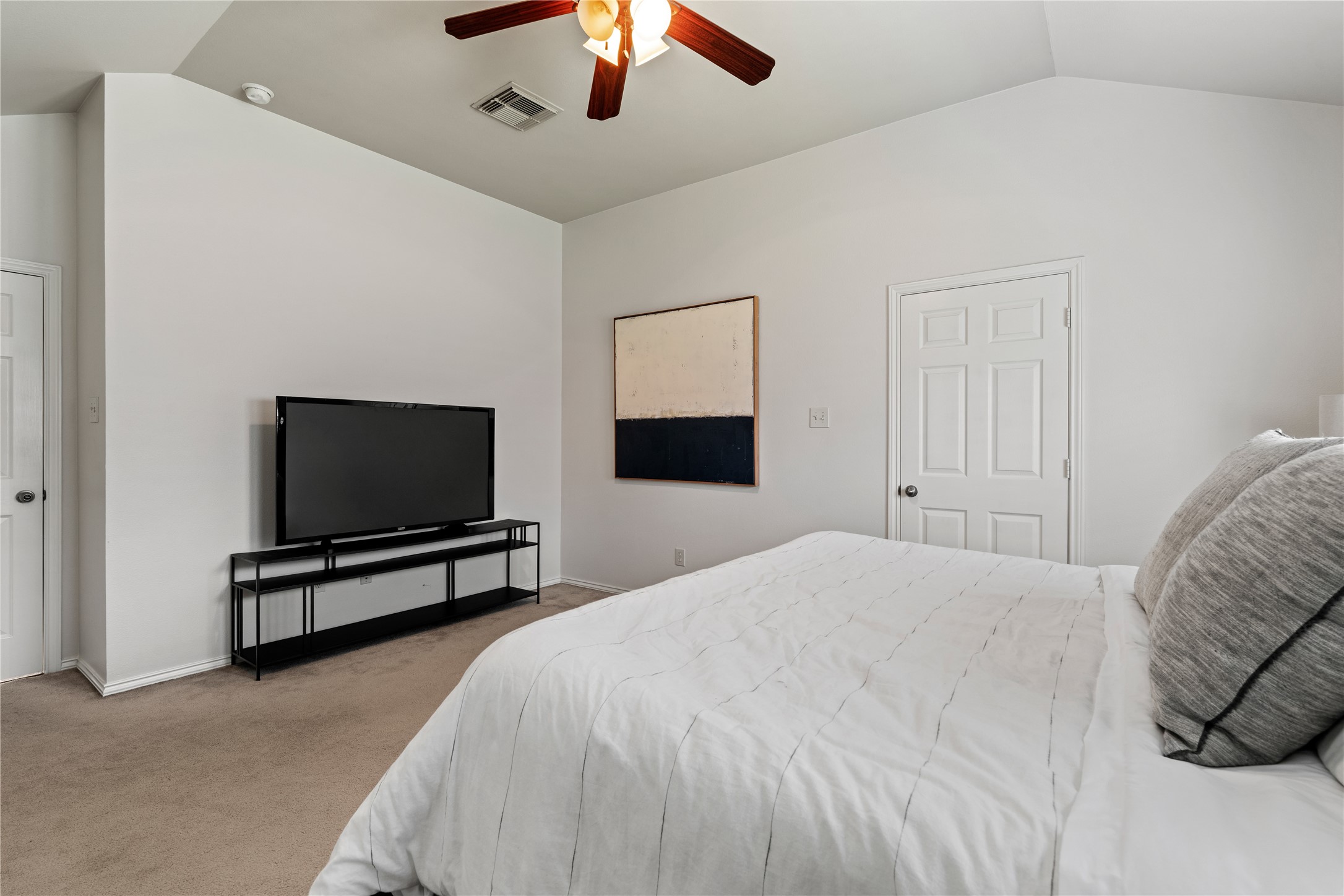 4323 Sunlit Pass Loop Humble, TX 77396 - Photo 17 of 30 a bedroom with a bed and a flat screen tv