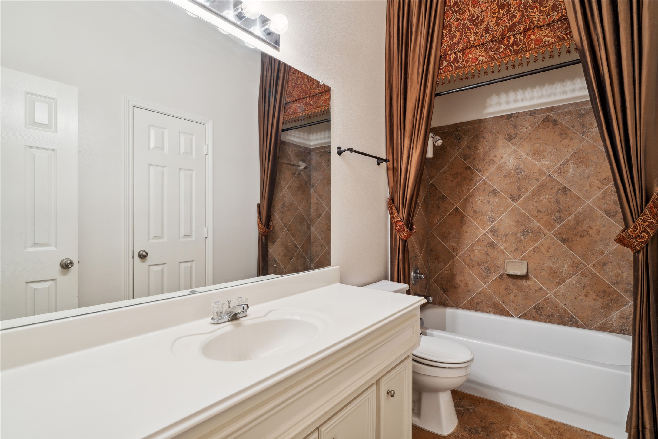4323 Sunlit Pass Loop Humble, TX 77396 - Photo 22 of 30 a bathroom with a sink and a mirror