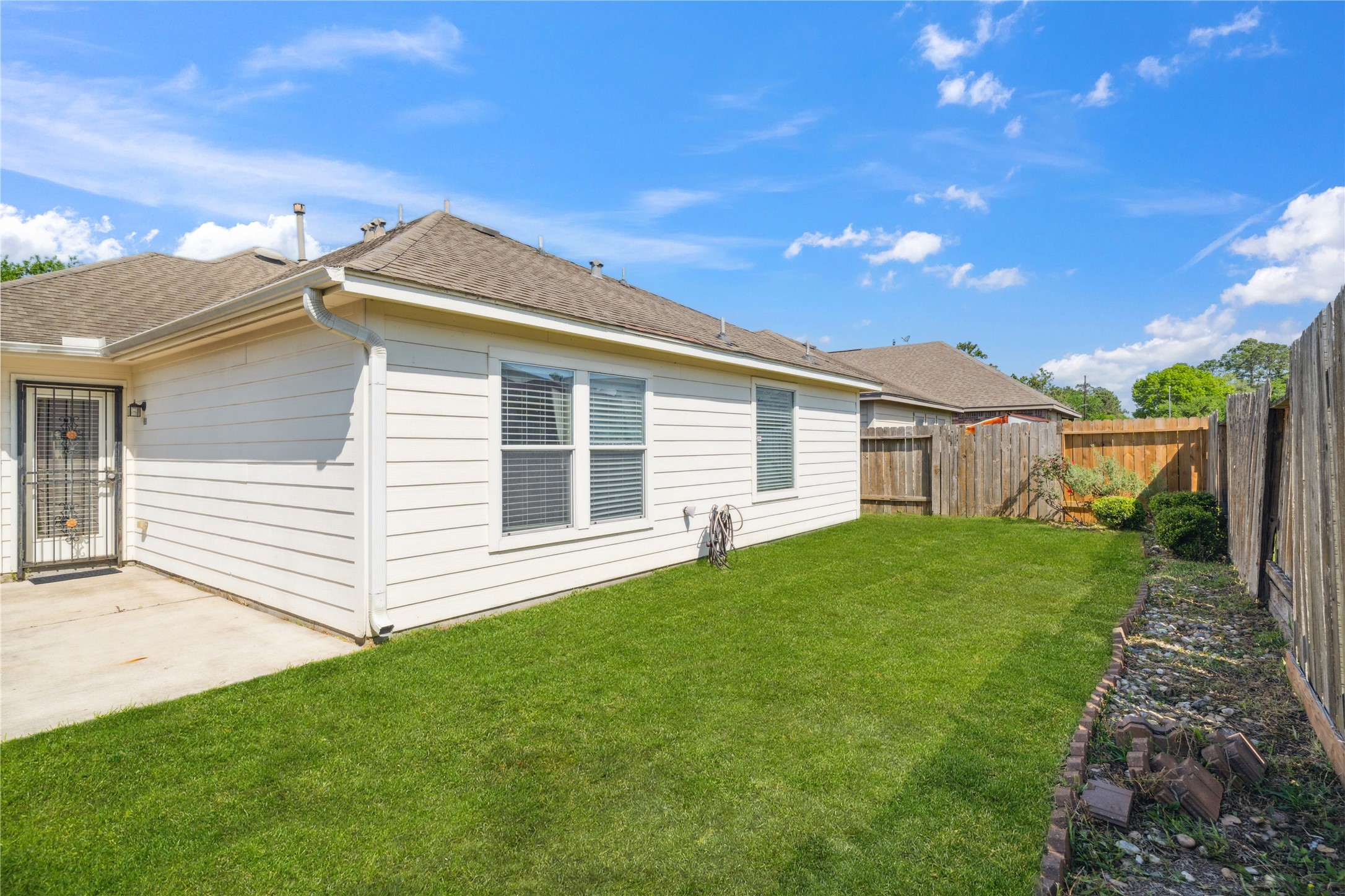 4323 Sunlit Pass Loop Humble, TX 77396 - Photo 24 of 30 a view of a house with a backyard
