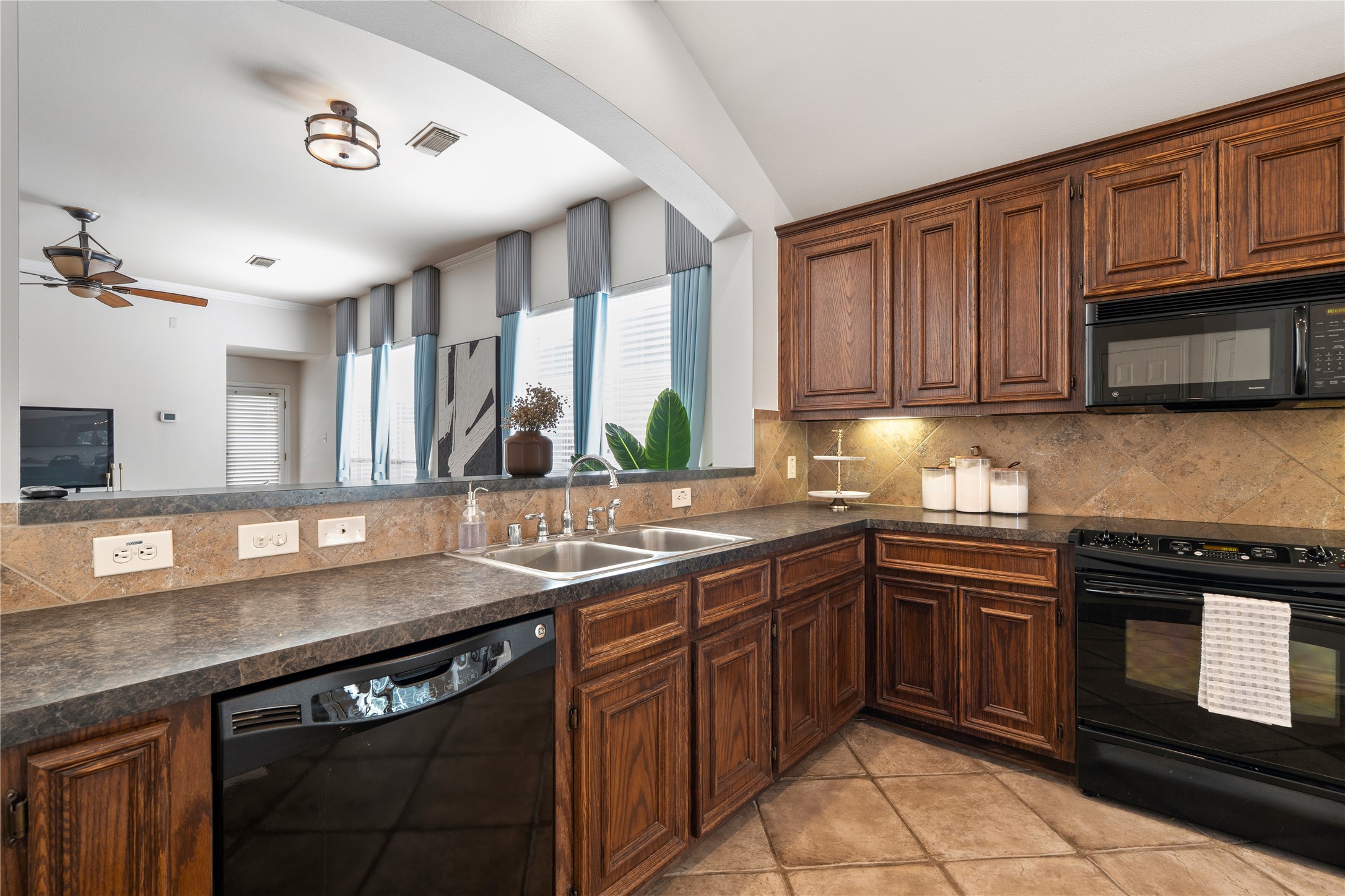 4323 Sunlit Pass Loop Humble, TX 77396 - Photo 4 of 30 a kitchen with stainless steel appliances granite countertop a sink stove and microwave