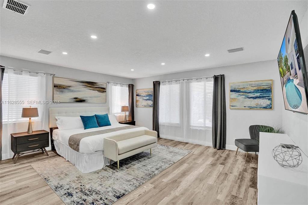 3421 Dover Road Pompano Beach, FL 33062 - Photo 11 of 22 a bedroom with a bed and wooden floor