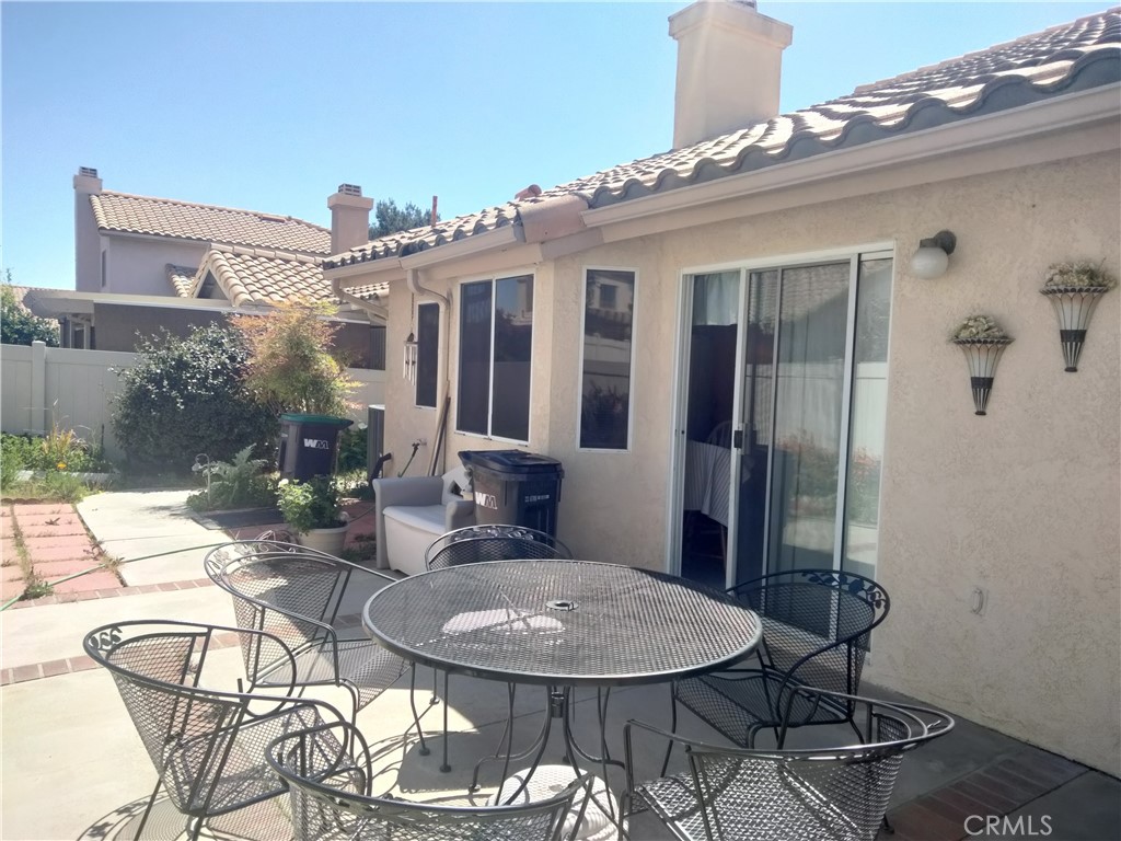 6353 Colonial Avenue Banning, CA 92220 - Photo 11 of 26 a view of a patio with table and chairs potted plants and floor to ceiling window