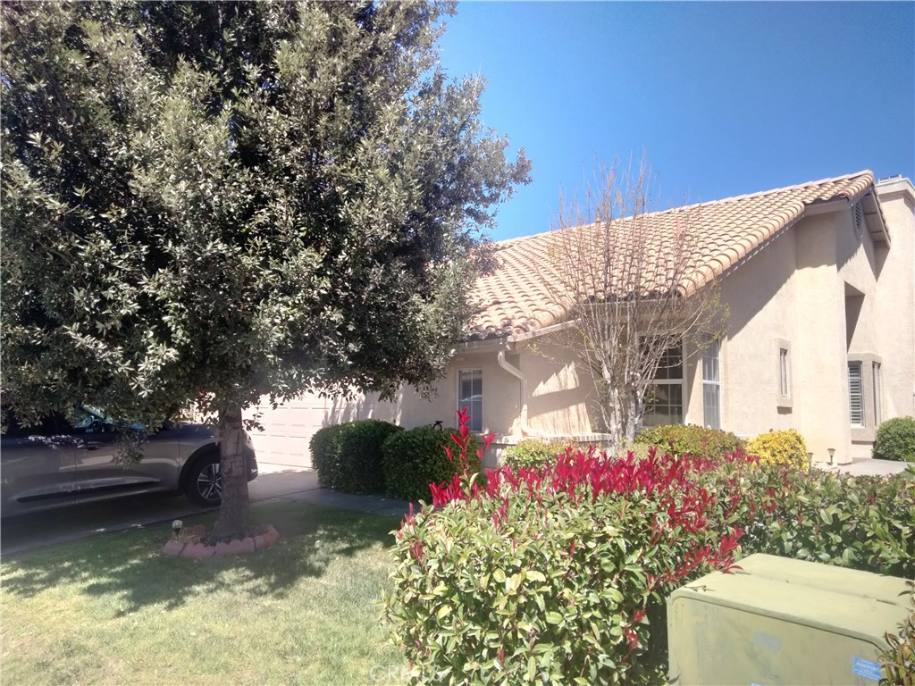 6353 Colonial Avenue Banning, CA 92220 - Photo 2 of 26 a front view of a house with a yard garage and fountain