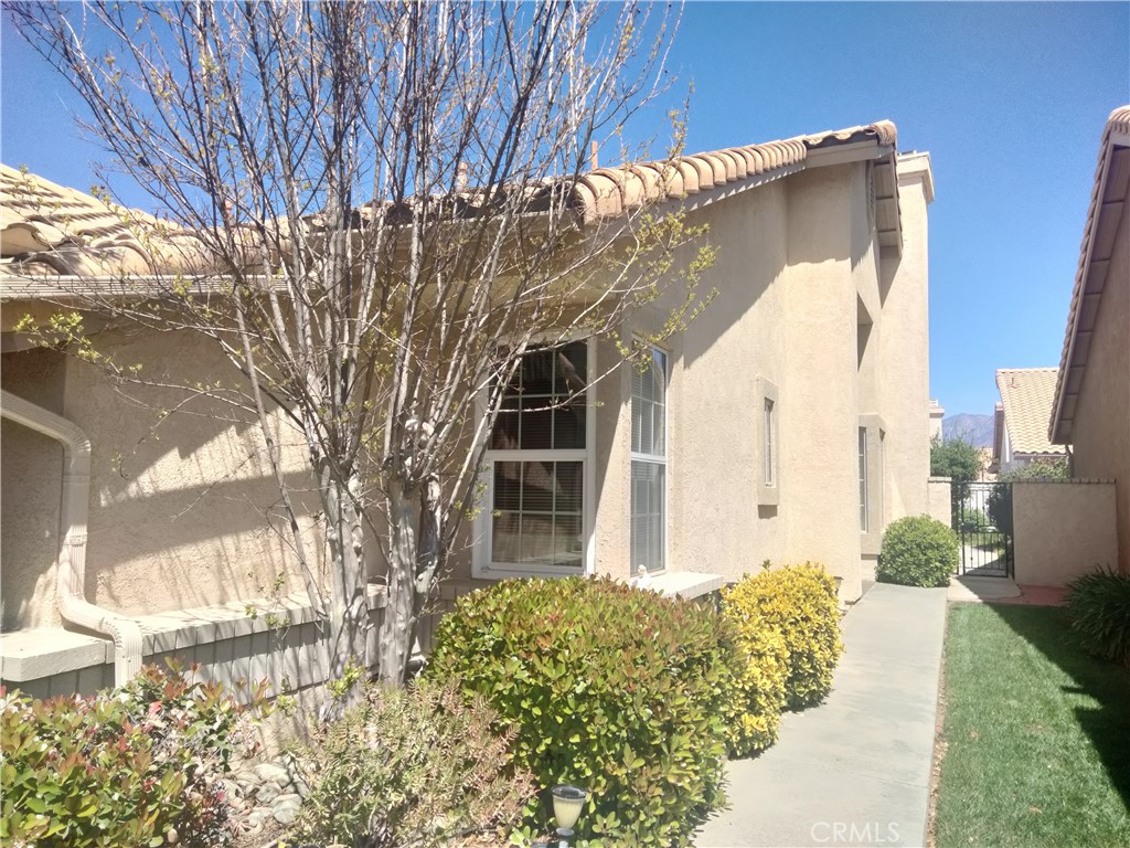 6353 Colonial Avenue Banning, CA 92220 - Photo 3 of 26 a front view of a house with a yard
