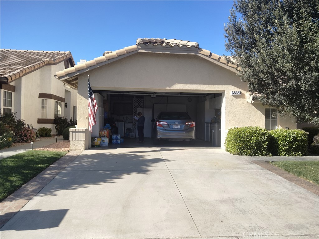 6353 Colonial Avenue Banning, CA 92220 - Photo 4 of 26 a front view of a house with a yard and a garage