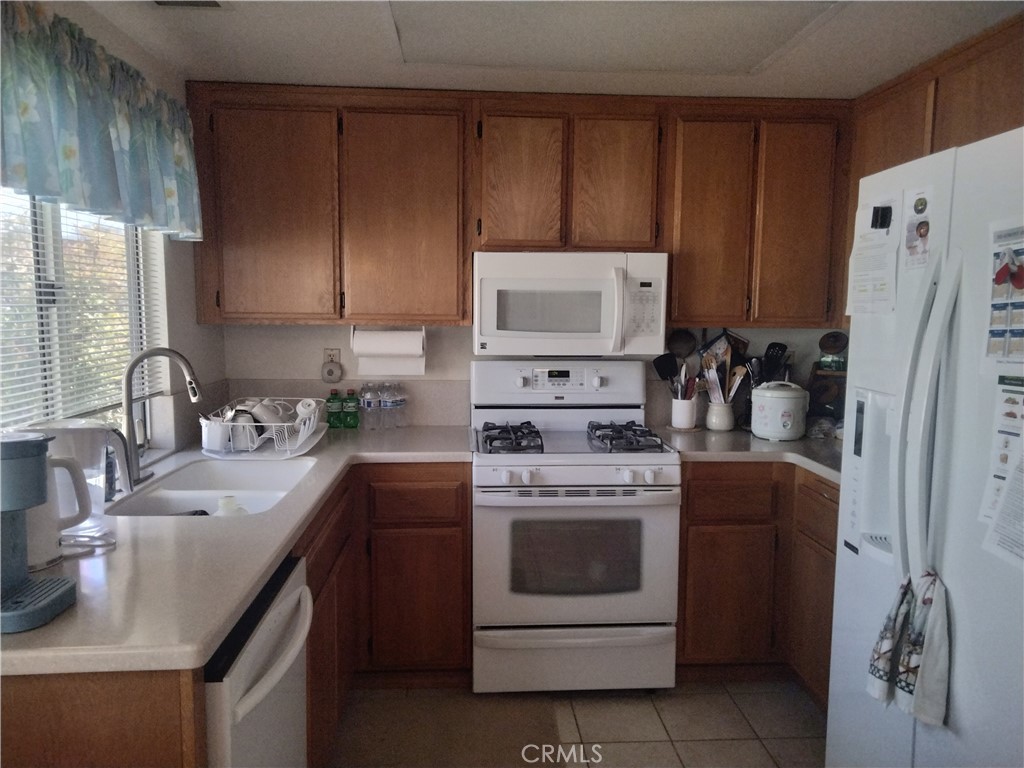 6353 Colonial Avenue Banning, CA 92220 - Photo 5 of 26 a kitchen with a stove sink and refrigerator
