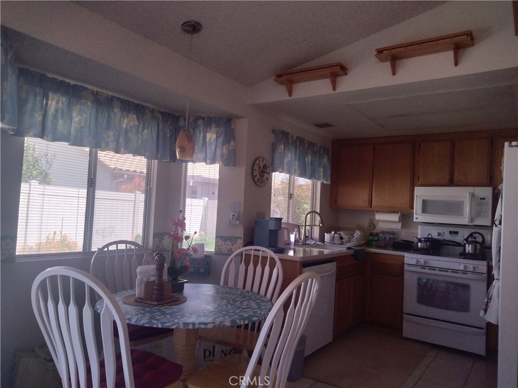 6353 Colonial Avenue Banning, CA 92220 - Photo 6 of 26 a kitchen with granite countertop a stove and a dining table