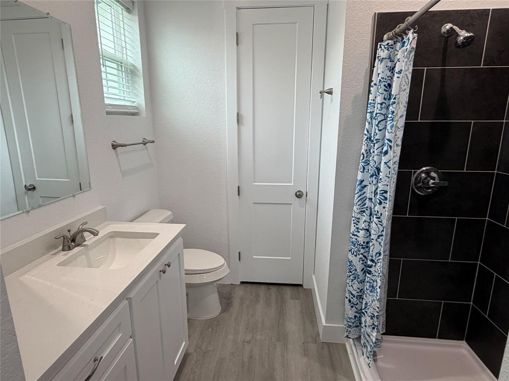 4200 Williams Road Bellmead, TX 76705 - Photo 15 of 22 a bathroom with a sink a toilet and shower