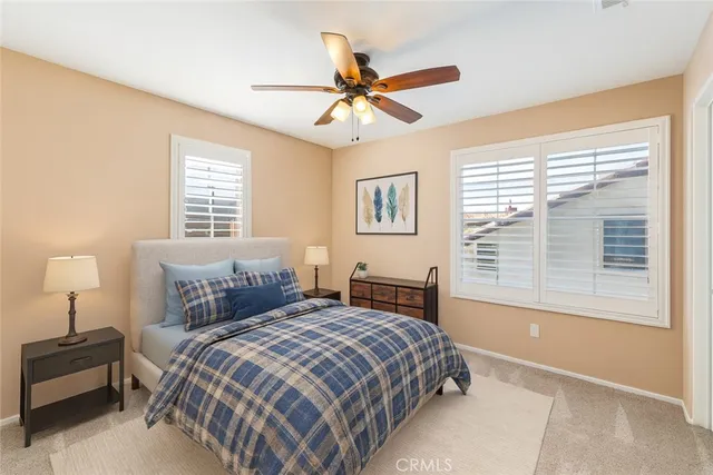 a bedroom with a large bed and a window