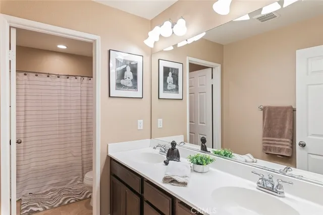 a bathroom with a double vanity sink and a mirror