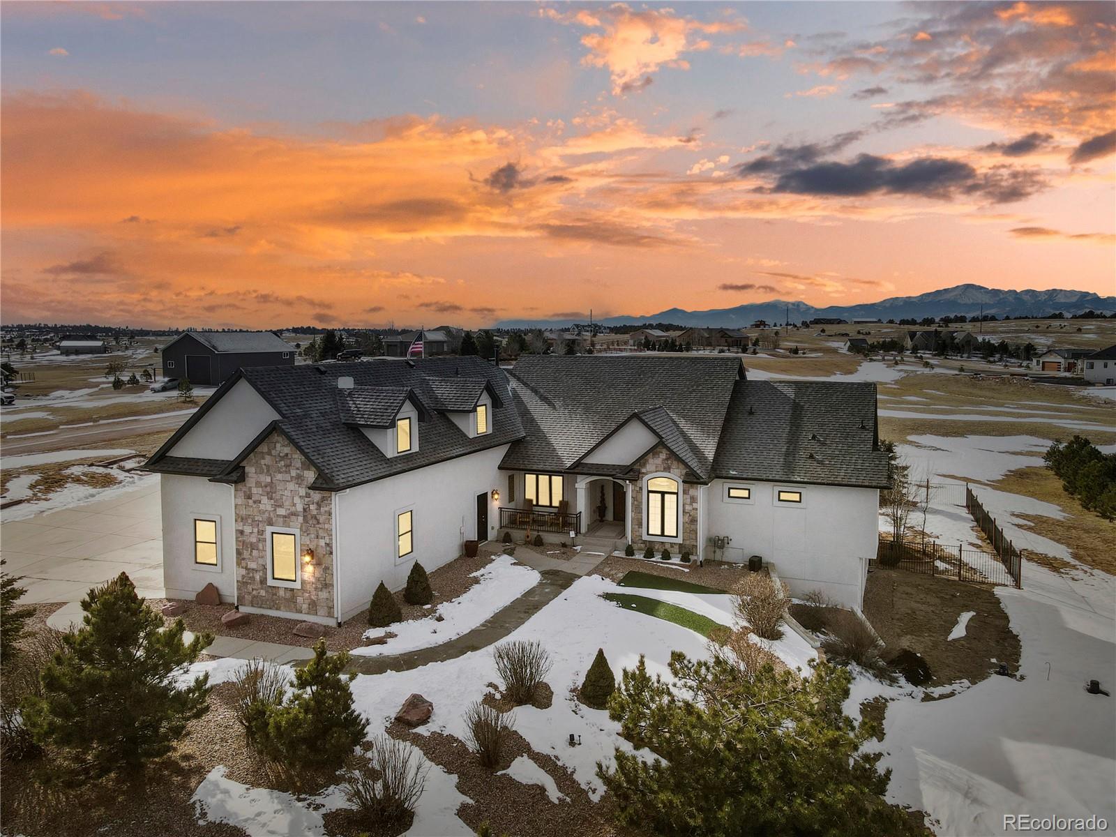 a view of a house with a yard next to a lake