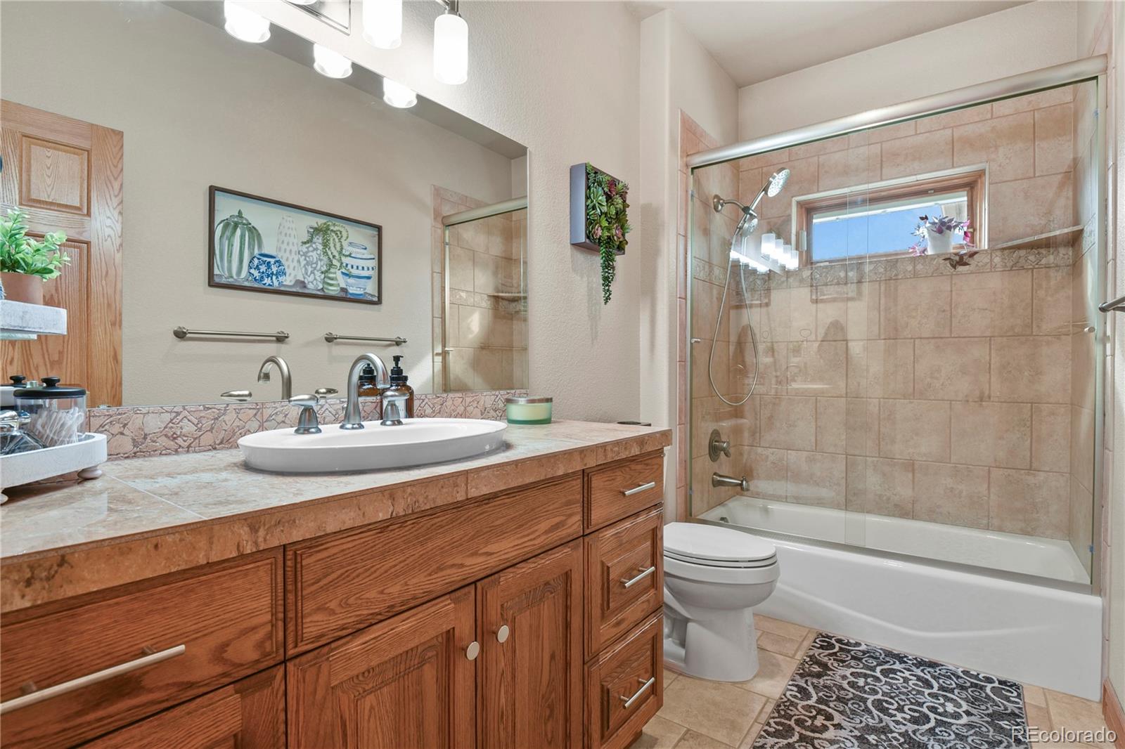 5220 Roundup Ridge Road Colorado Springs, CO 80908 - Photo 20 of 50 a bathroom with a sink a toilet and shower