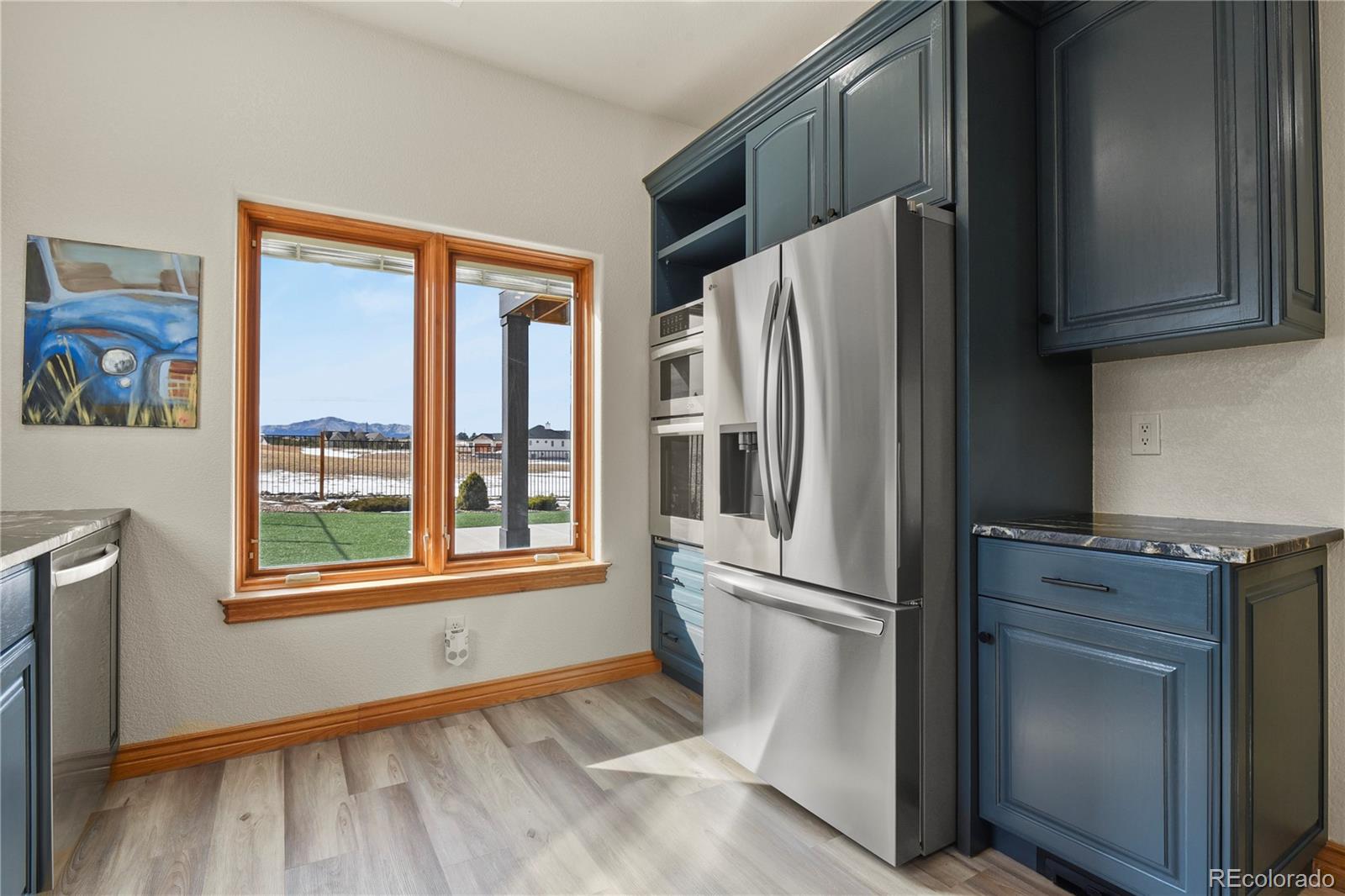 5220 Roundup Ridge Road Colorado Springs, CO 80908 - Photo 25 of 50 a kitchen with stainless steel appliances granite countertop a refrigerator and a stove top oven
