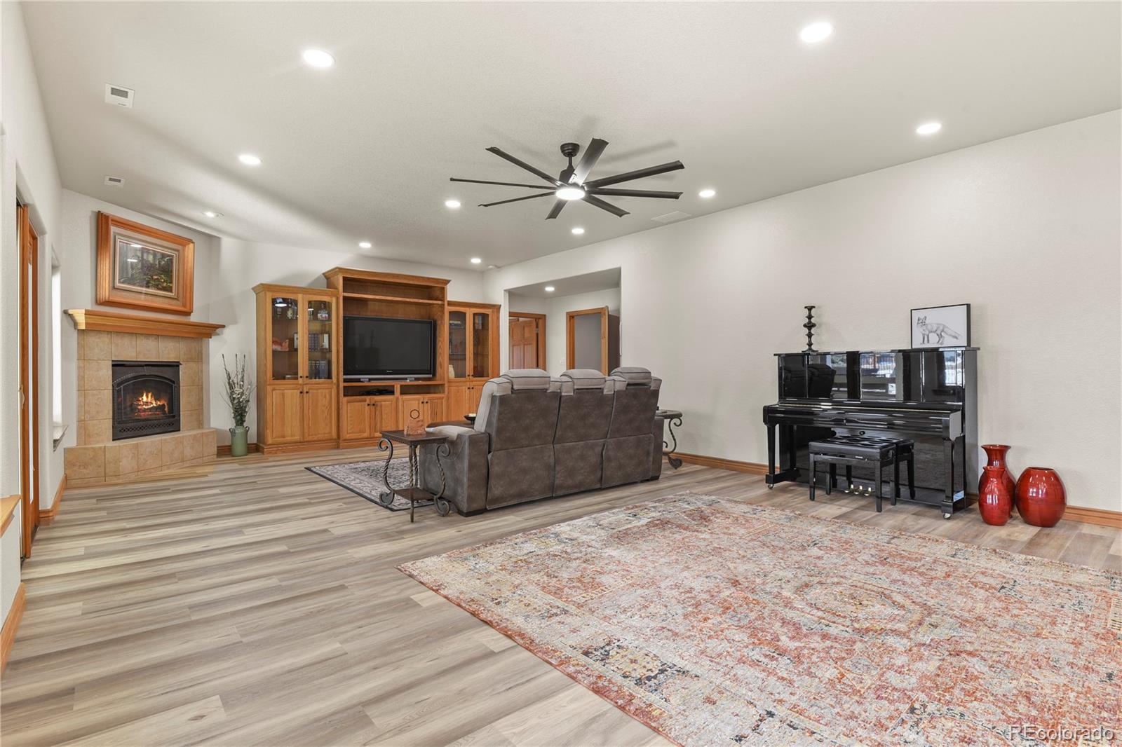 5220 Roundup Ridge Road Colorado Springs, CO 80908 - Photo 26 of 50 a living room with furniture and a flat screen tv