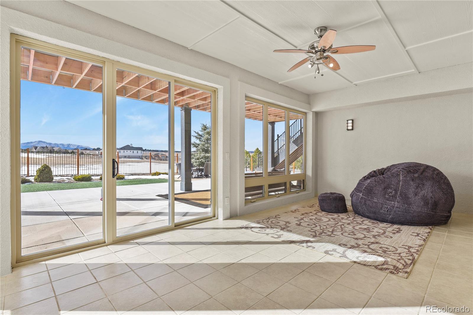 5220 Roundup Ridge Road Colorado Springs, CO 80908 - Photo 33 of 50 a very nice looking room with a large window and chandelier