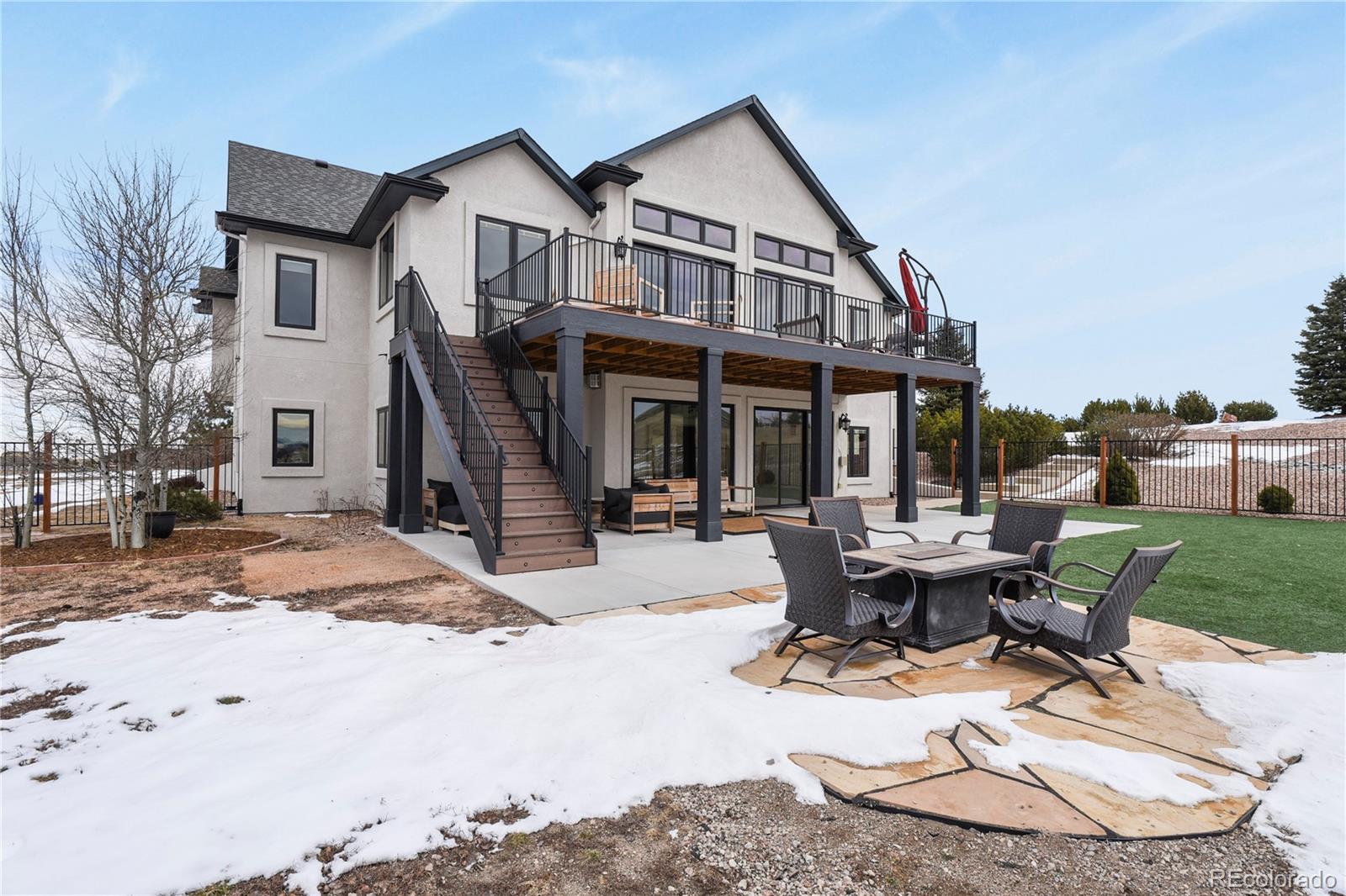 5220 Roundup Ridge Road Colorado Springs, CO 80908 - Photo 40 of 50 a view of a house with backyard porch and sitting area