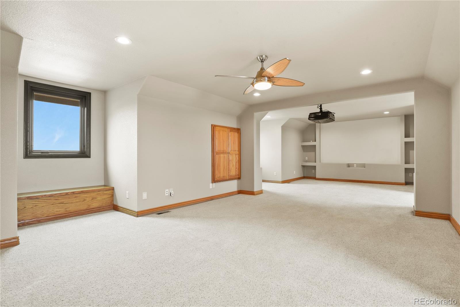 5220 Roundup Ridge Road Colorado Springs, CO 80908 - Photo 43 of 50 an empty room with chandelier fan and windows