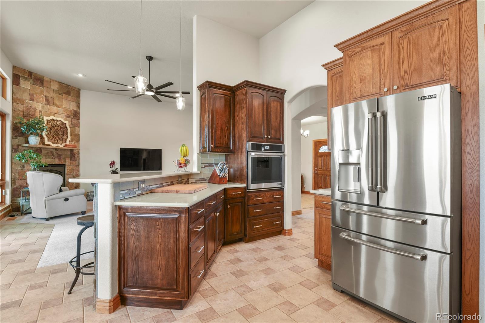 5220 Roundup Ridge Road Colorado Springs, CO 80908 - Photo 9 of 50 a kitchen with stainless steel appliances granite countertop a refrigerator a stove and a refrigerator