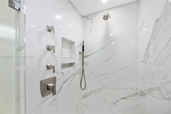 a bathroom with a shower and a glass door
