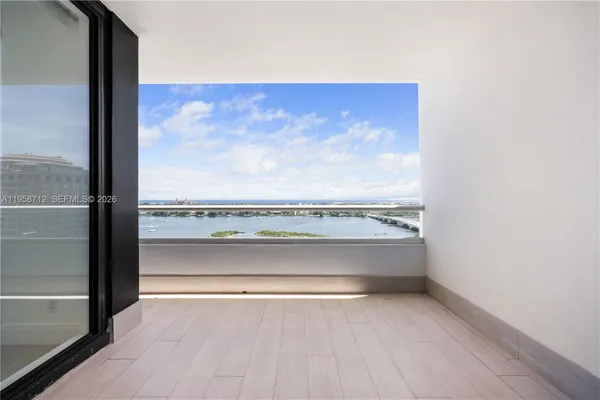 a view of a room with an empty space and a floor to ceiling window