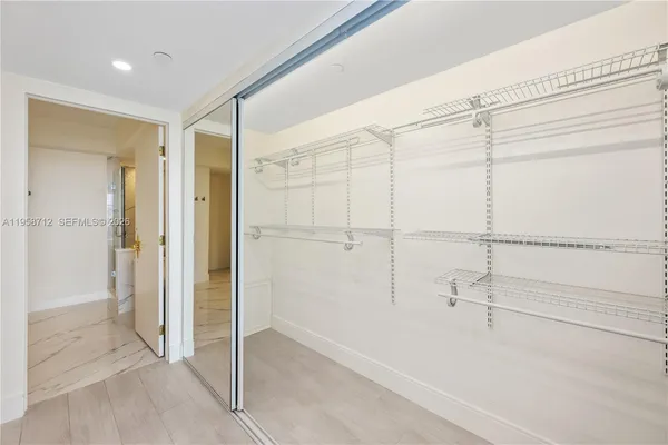 a bathroom with a shower and a glass door