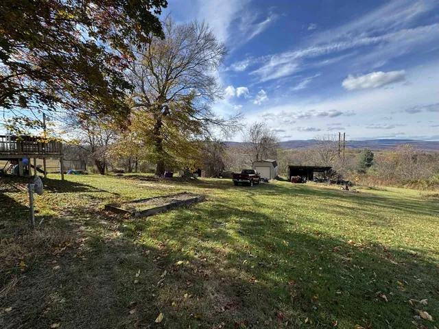 a view of a yard with cars parked
