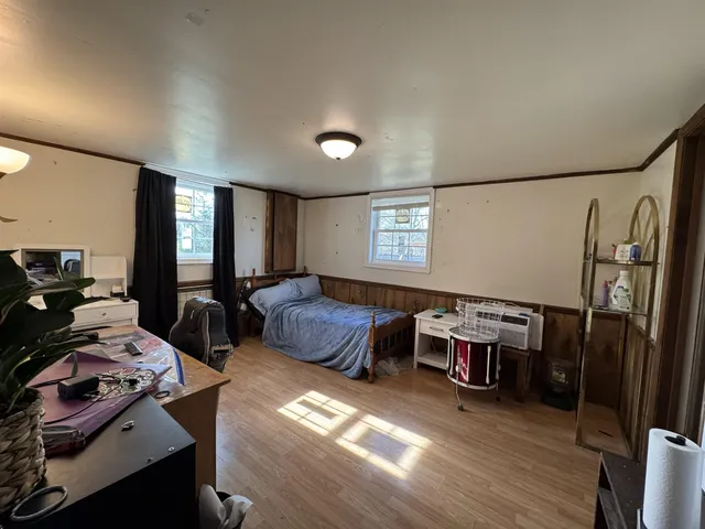 a bedroom with furniture and a window