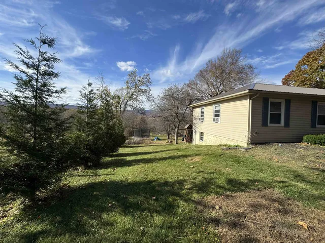 a view of a house with a yard