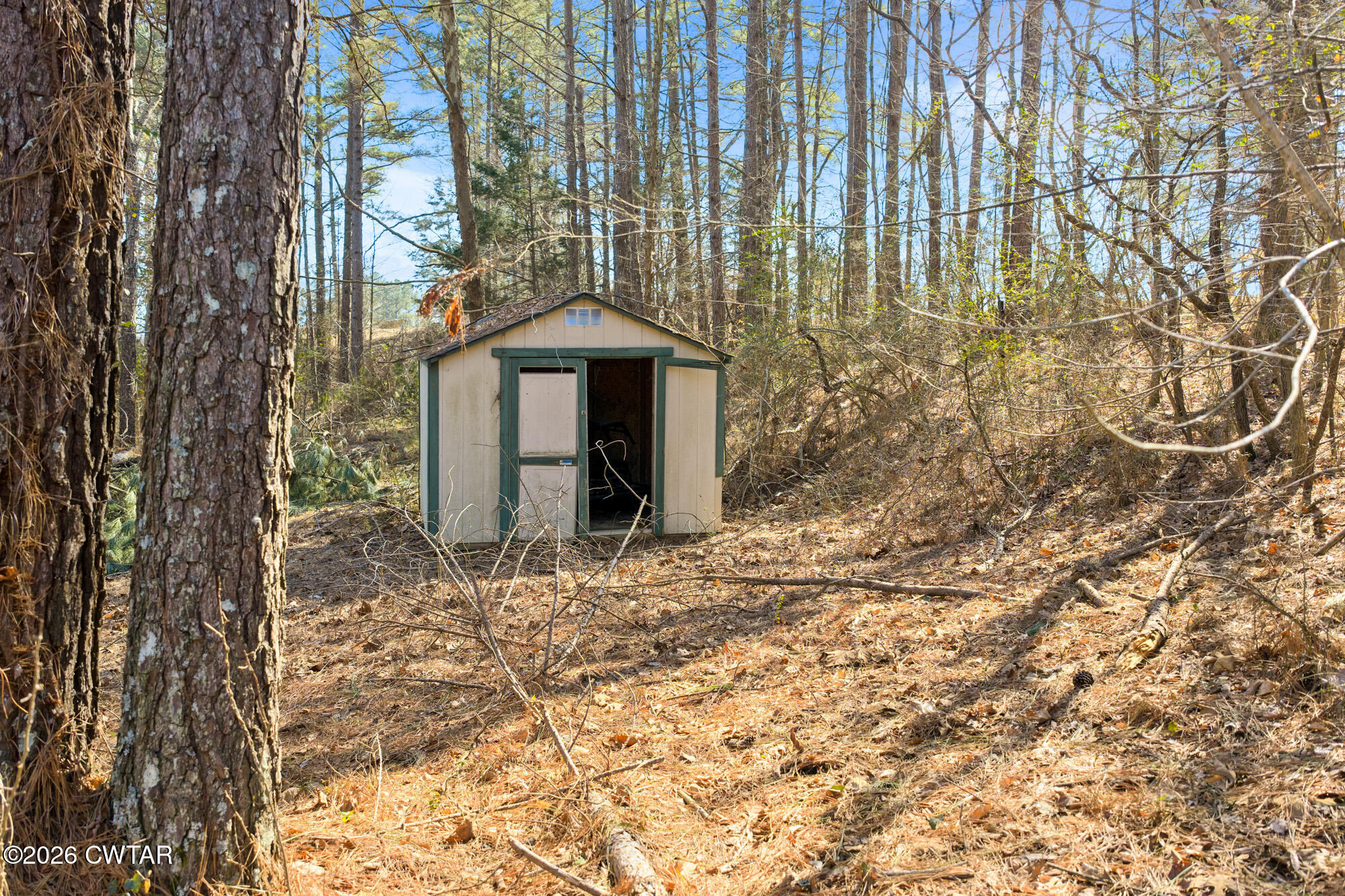 260 Myracle Town Road Parsons, TN 38363 - Photo 15 of 36 a front view of a house with a yard and garage